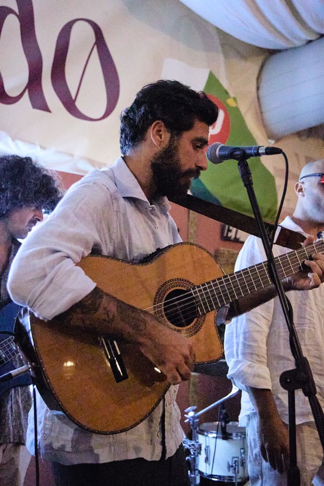 Músico con guitarra actuando en directo en la carpa